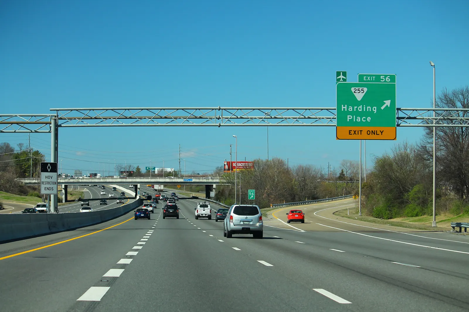 Tráfico en la autopista I-24 a la altura de la salida 56 de Nashville, con un pórtico de señalización verde que indica el desvío hacia Harding Place.
